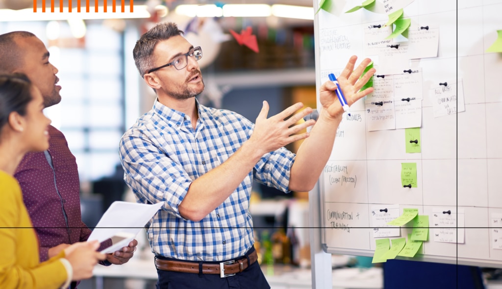 A group of colleagues discuss site reliability at SolarWinds