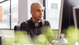 A man in an office is having a lovely time thinking about Kubernetes