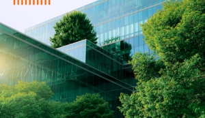 Glass office block with greenery and plants growing around it