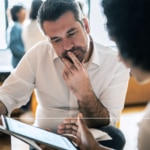 Man pondering at service desk