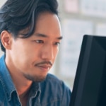 Man working at computer looking at database stuff