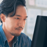 Man working at computer looking at database stuff
