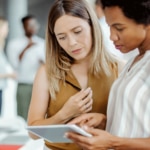 Colleagues working together on solving a problem using SolarWinds