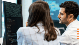 Two people looking at a computer screen solving customer issues