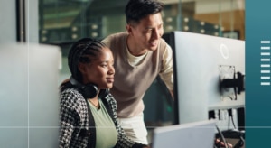 Two people looking at a screen together.