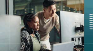 Two people looking at a screen together.