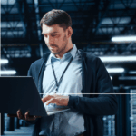 A man searches on his laptop for information on AWS and observability.