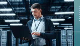 A man searches on his laptop for information on AWS and observability.