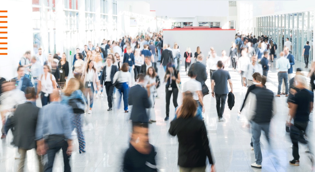 Businesspeople walking through a busy area with a blurred effect on the image