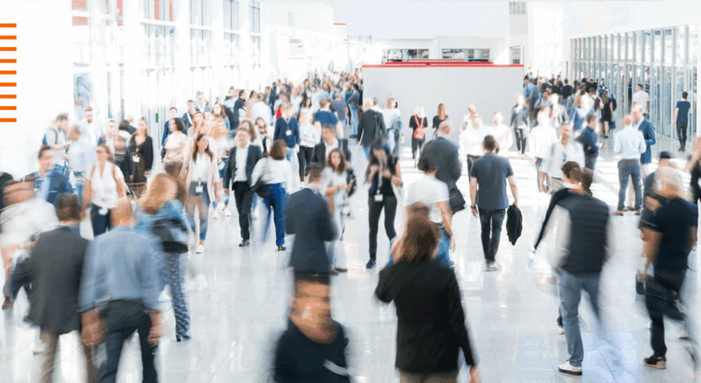 Businesspeople walking through a busy area with a blurred effect on the image