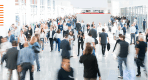 Businesspeople walking through a busy area with a blurred effect on the image