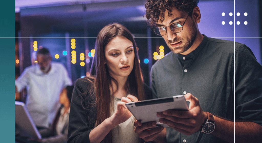 Two people looking at a tablet together