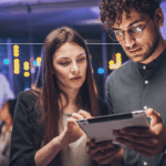 Two people looking at a tablet together