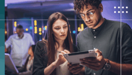 Two people looking at a tablet together